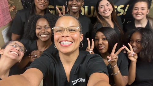 instructor posing with medical assistant students after graduation